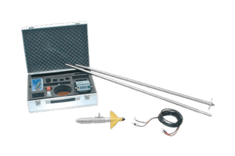 A metal carrying case with foam inserts holds the current meter with synthetic propeller, including two long metal rods, a yellow-fin aerial, and black and red connecting leads displayed on a white surface.