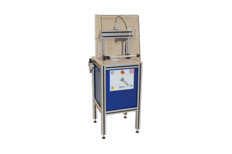 The Compression Test Apparatus Set is a compact industrial machine featuring a blue control panel, buttons, and a lever, with a transparent protective enclosure over its working area and four adjustable legs for stability.