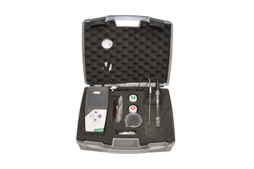 The pH Meter Set for Soil and Water is a portable scientific testing kit in an open black case with foam padding, containing a digital meter, probes, bottles with coloured caps, a cup, and other accessories neatly organised in compartments.