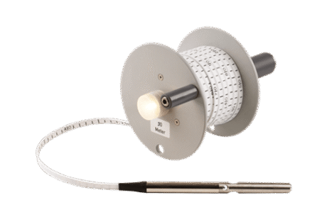The Water Level Meter is a handheld device with a reel, graduated tape, and attached probe, designed for measuring water levels in wells or tanks.
