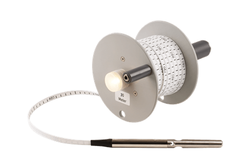 The Water Level Meter is a handheld device with a reel, graduated tape, and attached probe, designed for measuring water levels in wells or tanks.