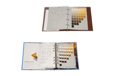 Two open Soil Colour Books with plastic sheets; the top shows greyscale and brown gradient swatches, while the bottom displays circular brown and grey swatches over a photo background.
