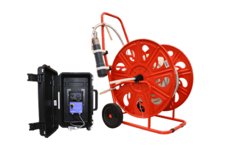 An MP1 Submersible Pump on a large red wheeled hose reel is placed next to an open black case with electronic equipment, connected by cables, all set against a plain white background.